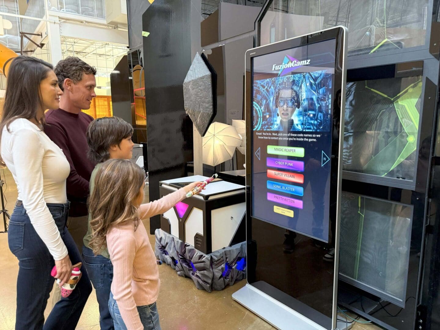 Family interacting with gaming touchscreen display.